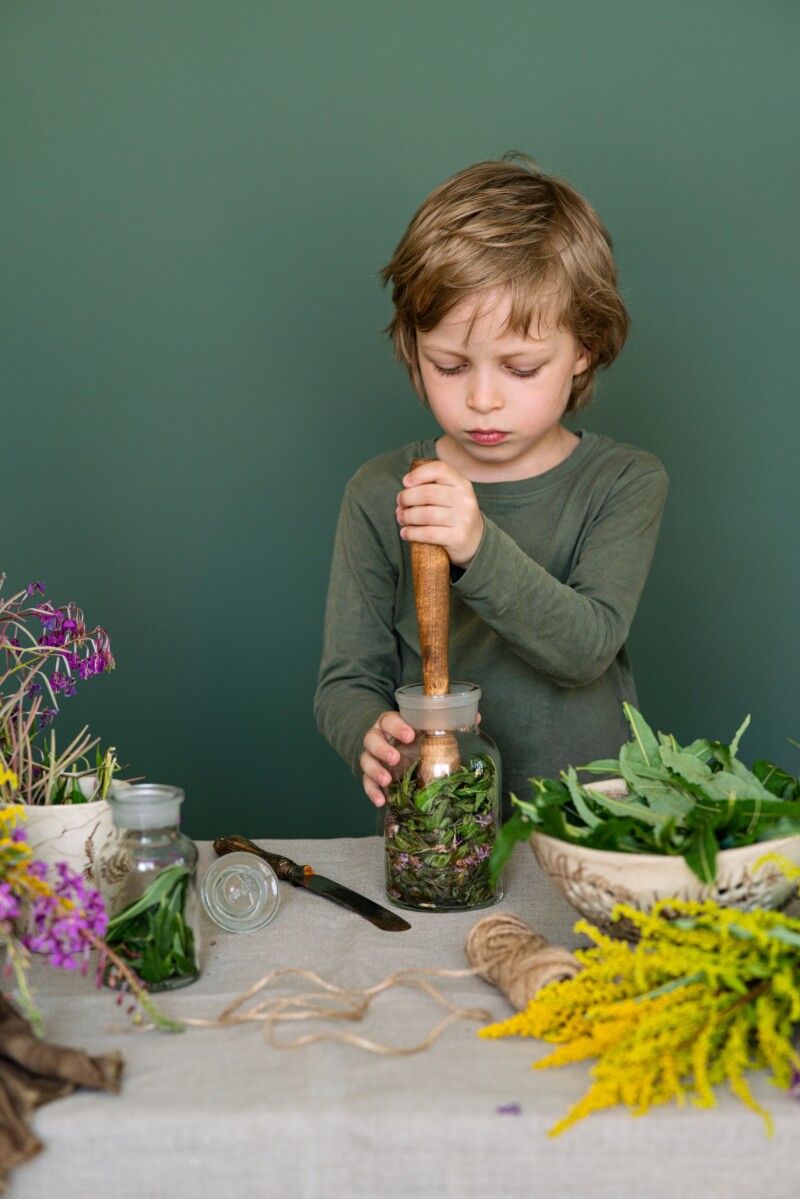 glass bottles with small round pills near mortar and pestle, wooden spoon, jar and green leaves on - Wholistic Healing, Naturopathic Care, About Us - IV Therapy - MedLink Health Solutions - Dr. Samantha Ramanan - Dr. Sam - Naturopathic Physician in AZ