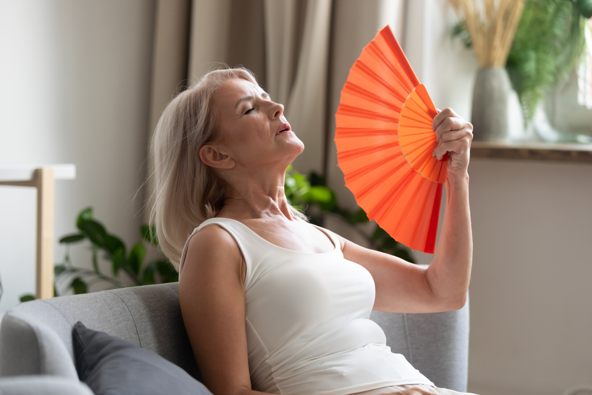 Woman experiencing hot flashes as a menopausal symptom